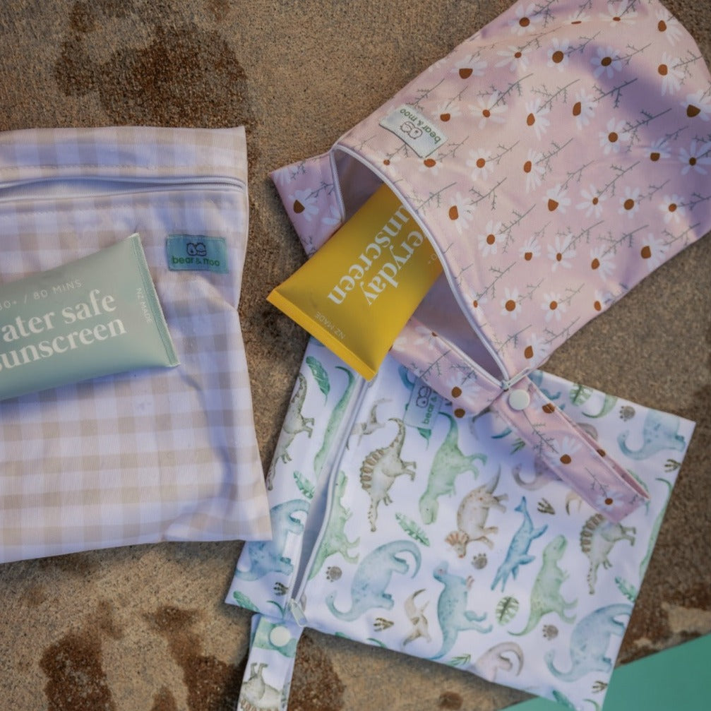 Bear & Moo Swimsuits | Medium Wet Bags in Oat Gingham, Daisy & Dinosaurs | available at Bear & Moo