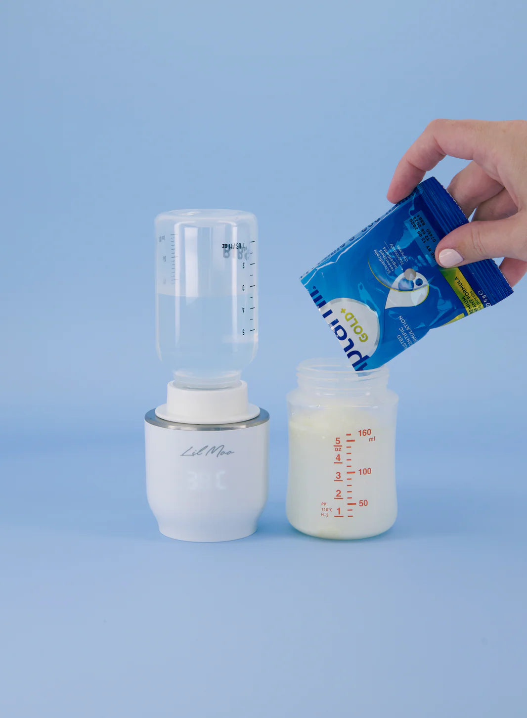 Person opening a blue formula pouch over a white bottle with measurement markings on a light blue background.