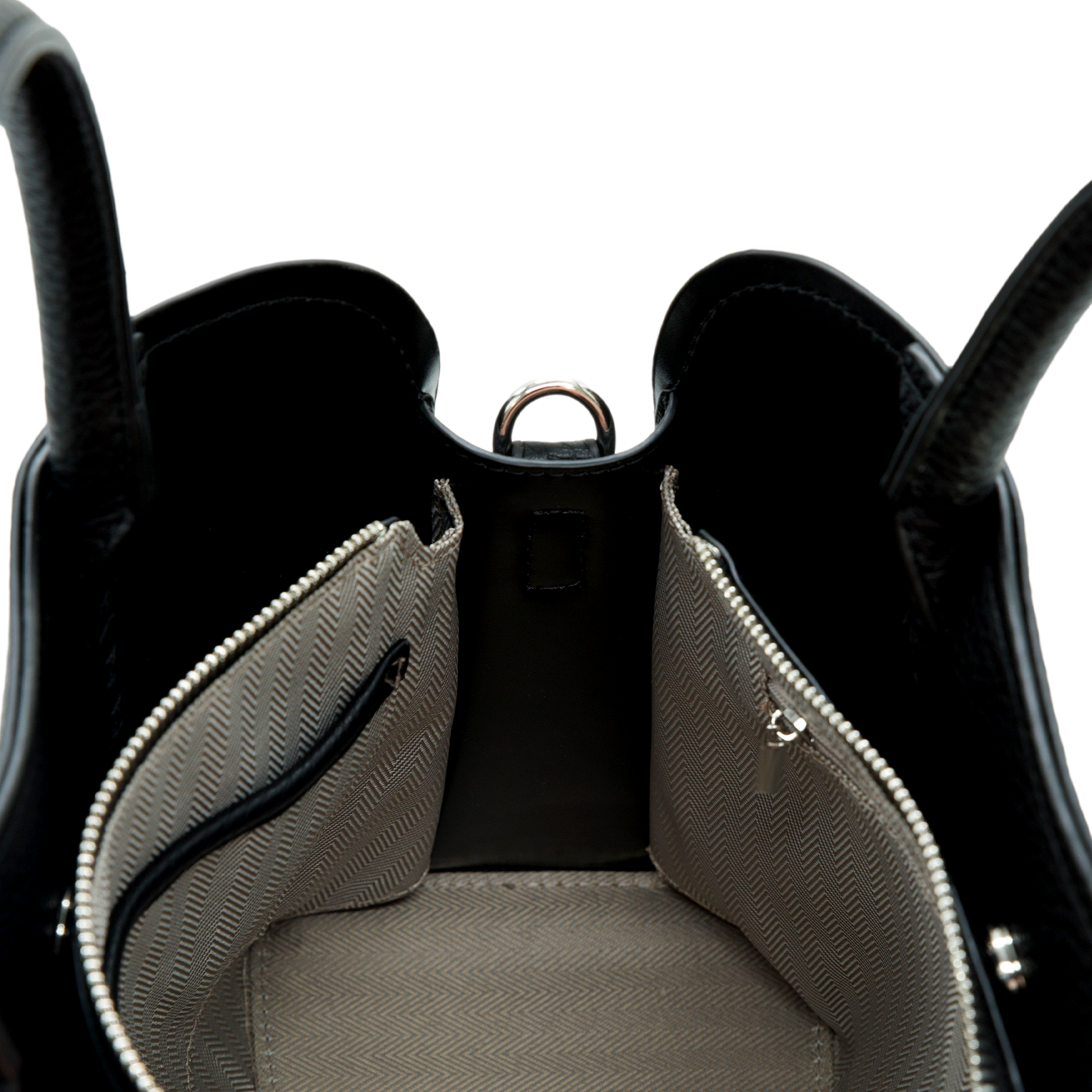 Close-up of a black vegan leather handbag with open front pocket on a white background