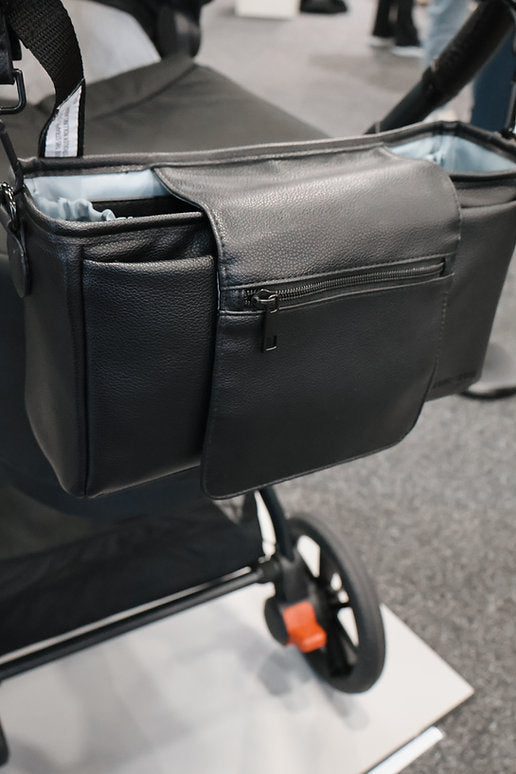 Black vegan leather bag with a zipper on a blurred background